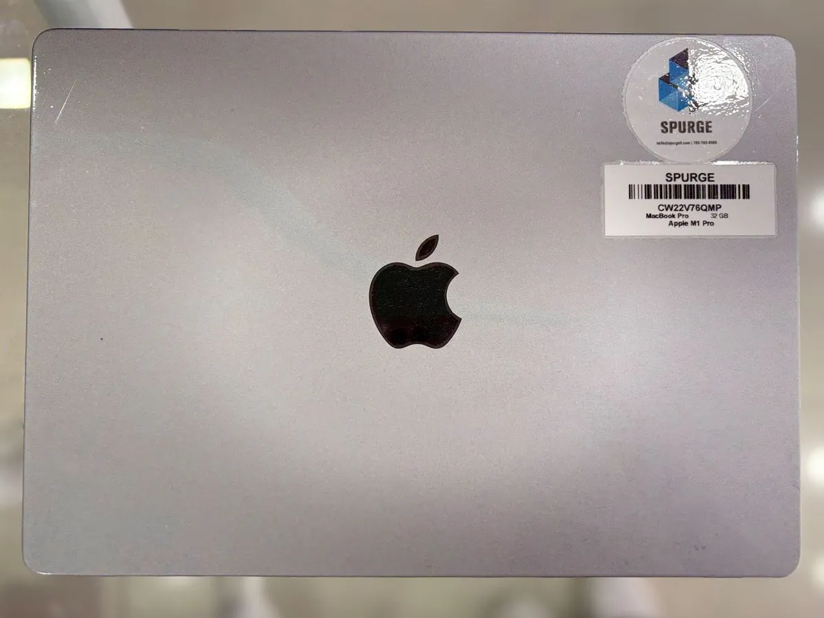 MacBook Pro 14-inch M1 Pro closed, lid facing up showing the Apple logo and the SPURGE asset label reading MacBook Pro 32 GB Apple M1 Pro
