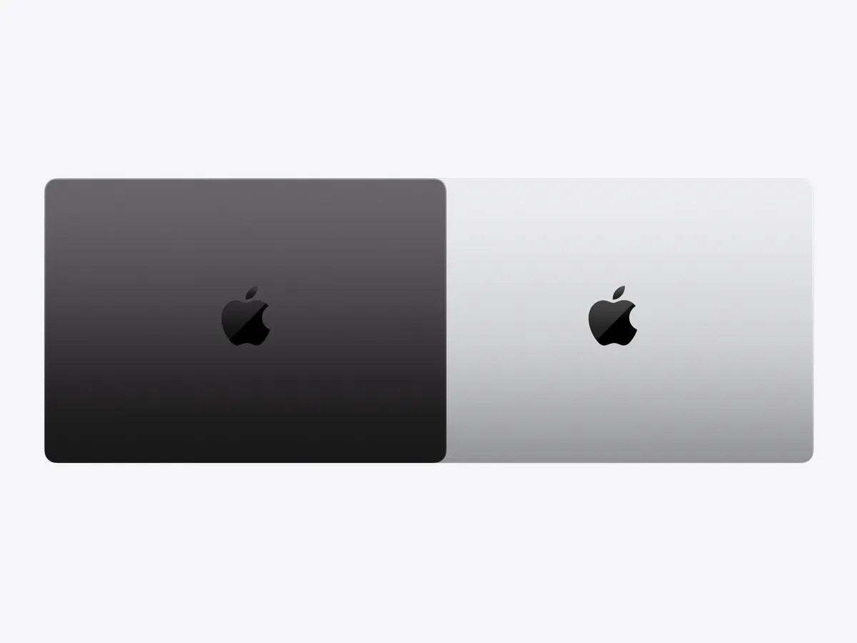 Closed 14-inch MacBook Pro lids in Space Black and Silver, seen from above