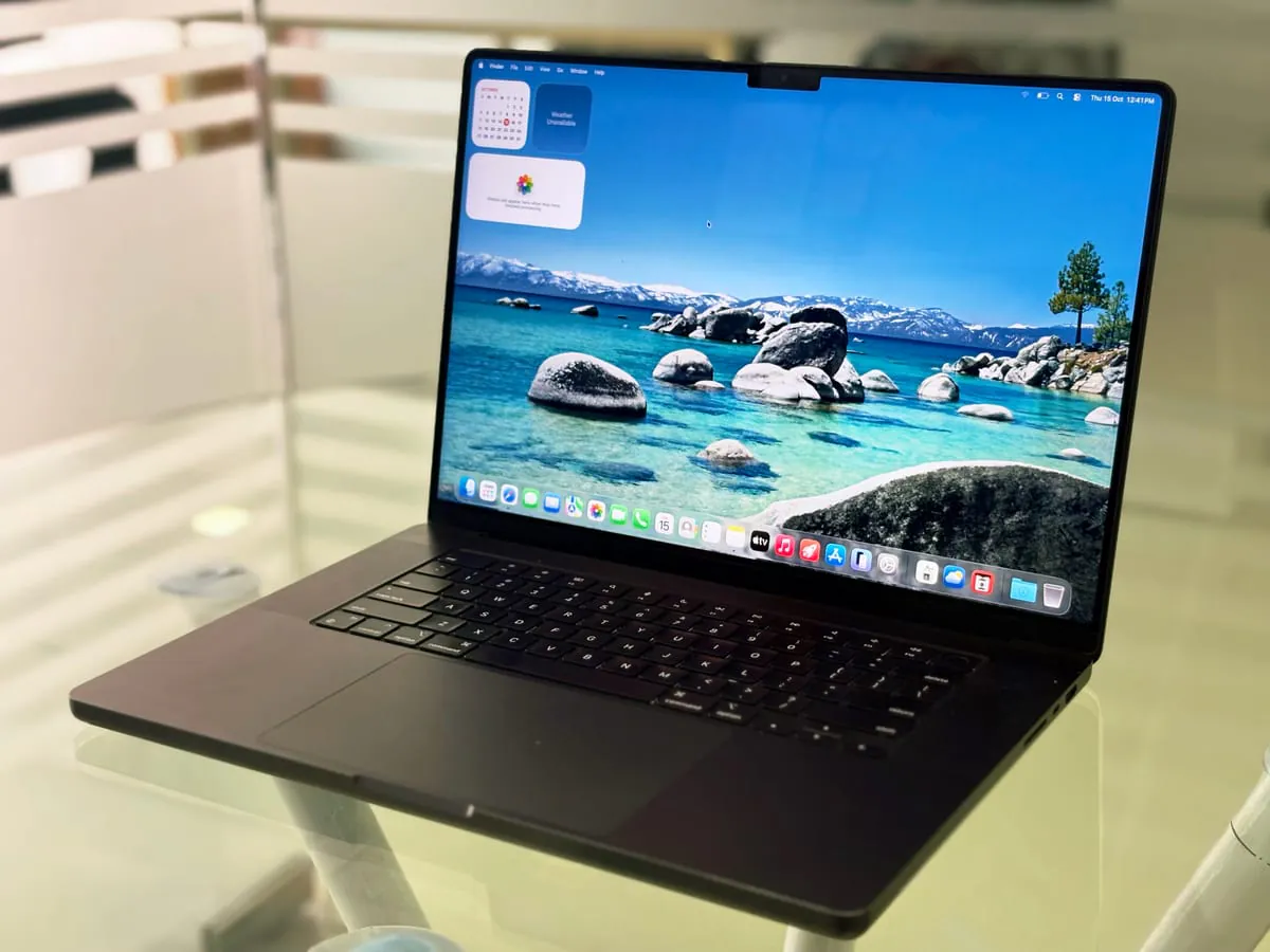 MacBook Pro 16-inch M3 Max in Space Black, open at a left three-quarter angle showing the display, keyboard and trackpad