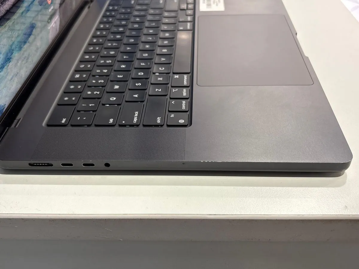 MacBook Pro 16-inch M4 Pro close-up of the keyboard and trackpad, with the left-side ports at the edge