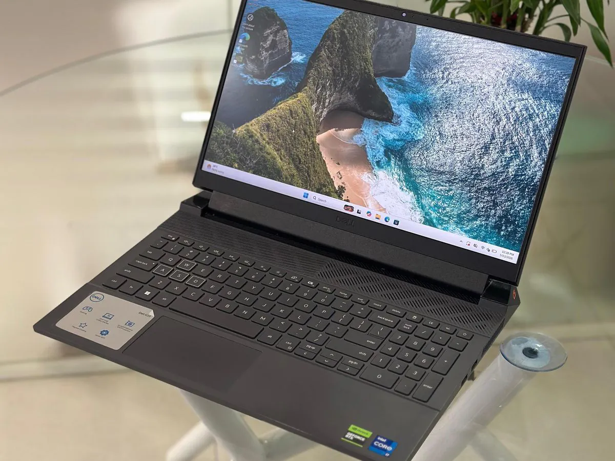 Dell G15 5530 open at an angle with the 15.6-inch display on, backlit keyboard and numeric keypad visible