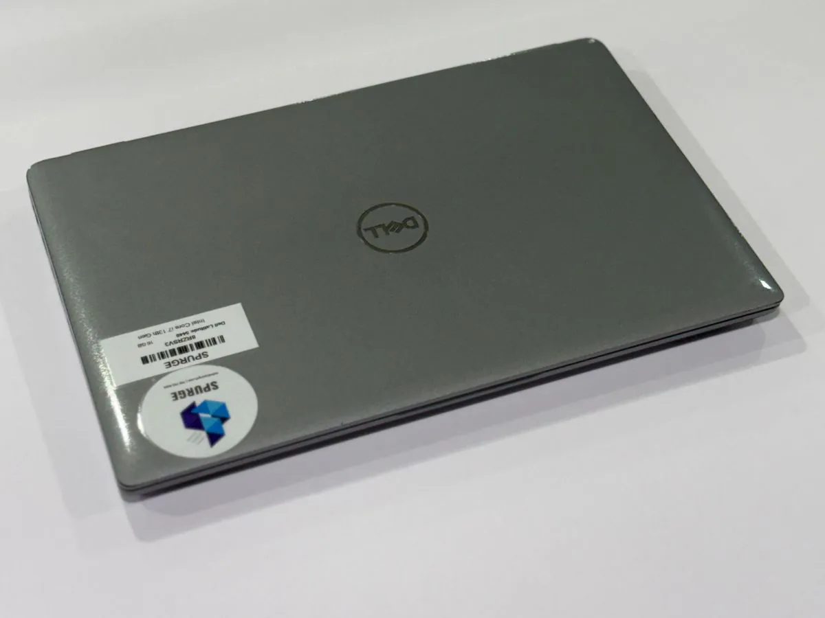 Dell Latitude 5440, closed grey lid with Dell branding and SPURGE asset labels.