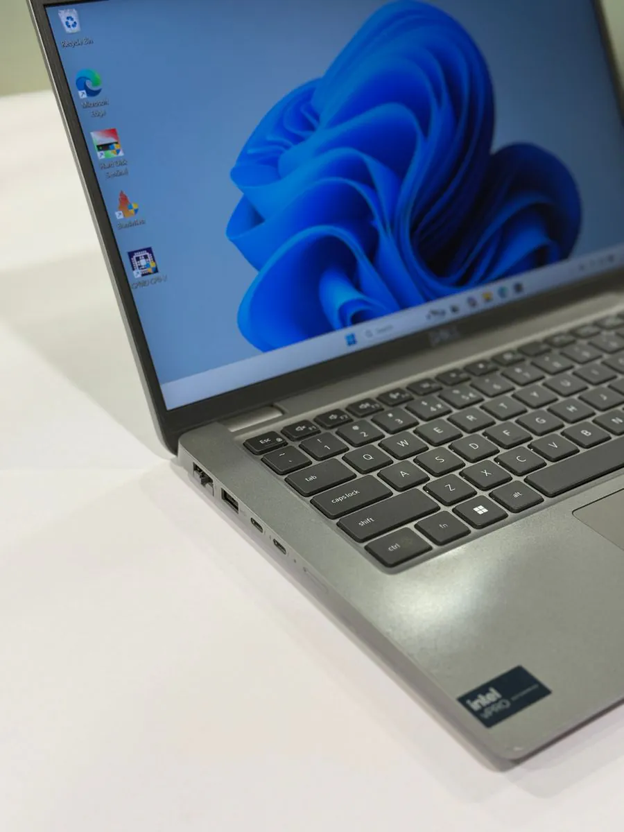Dell Latitude 5450, left-side detail showing the keyboard edge, ports and palm rest.