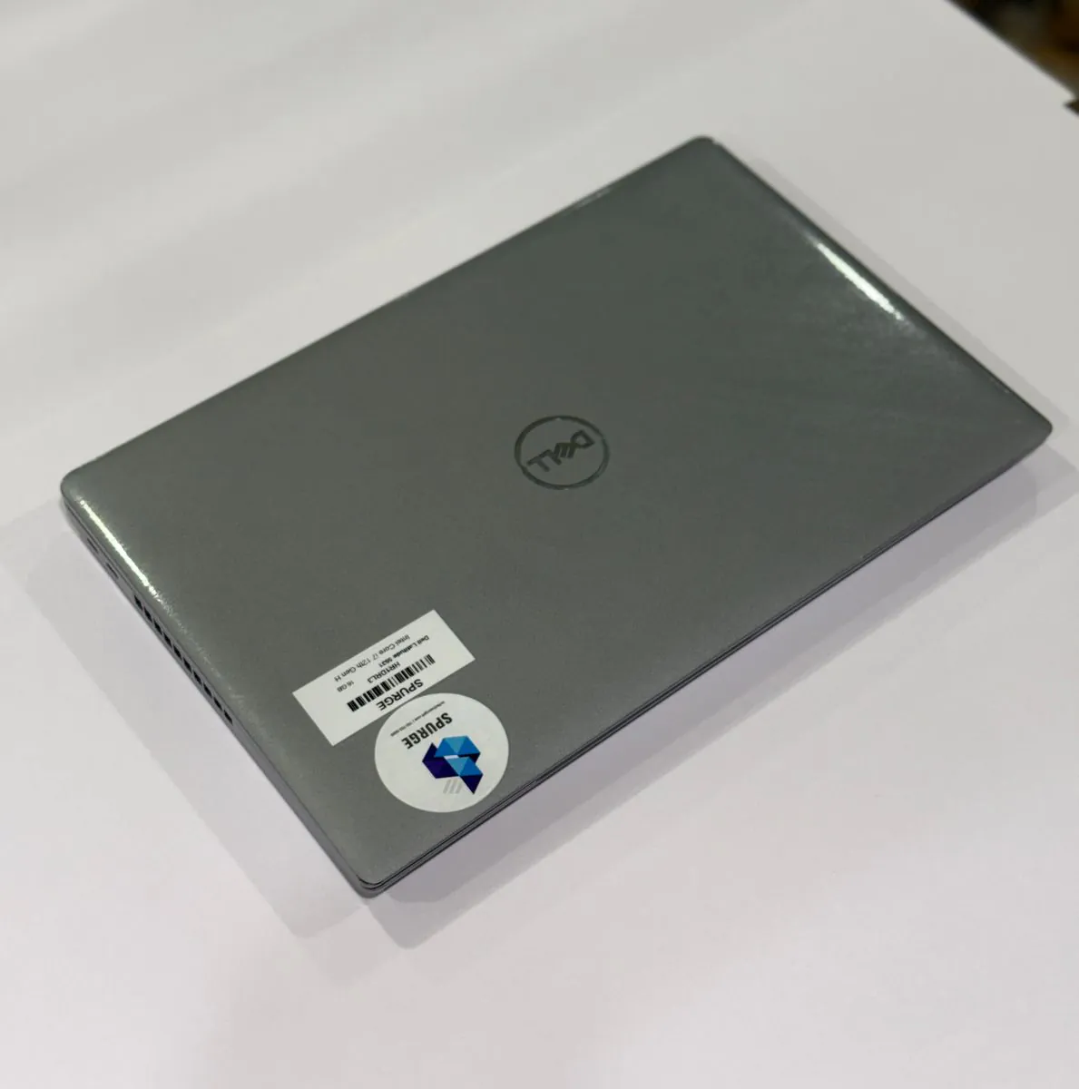 Dell Latitude 5531, closed lid with Dell branding and SPURGE asset labels.