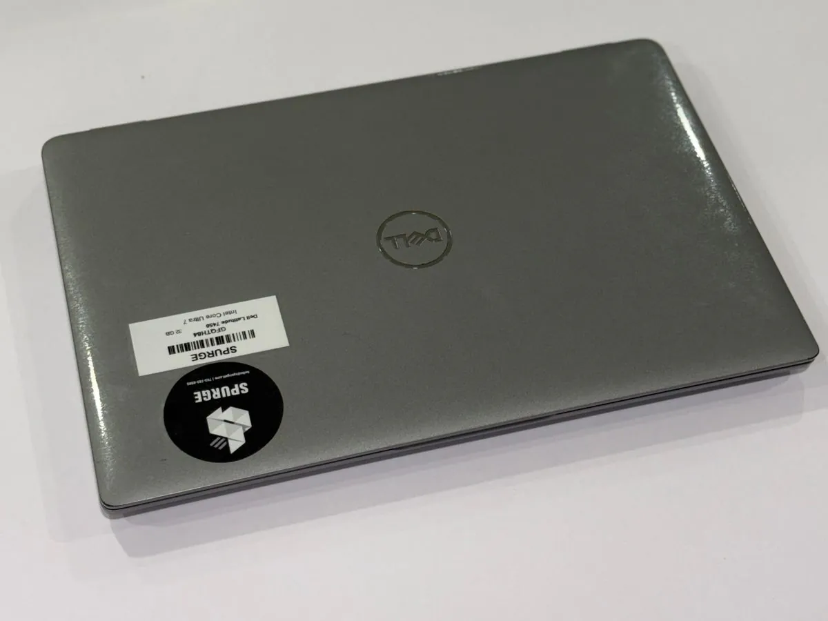 Dell Latitude 7450, closed lid with Dell branding and SPURGE asset labels.