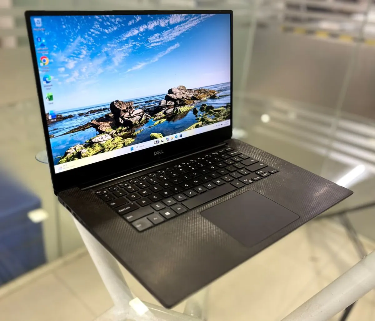Dell Precision 5530, open, three-quarter view from the left showing the display, keyboard, trackpad and left-side ports