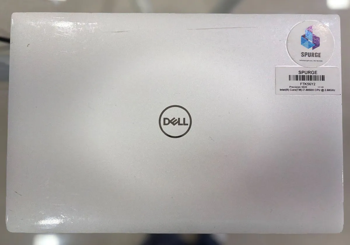 Dell Precision 5530 closed, silver aluminium lid with the Dell logo and SPURGE asset stickers