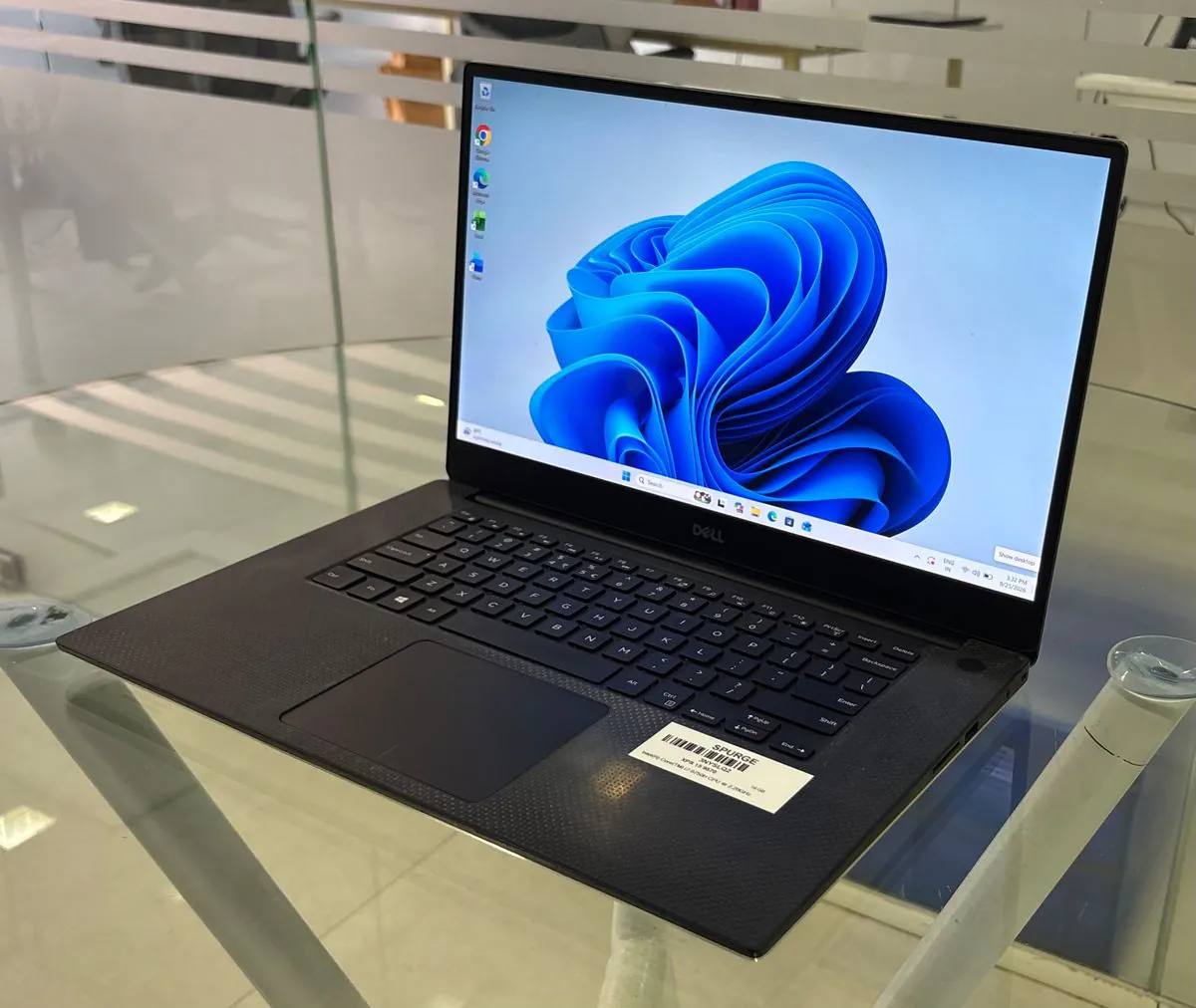 Dell XPS 15 9570, open, three-quarter view from the right showing the display, keyboard and right-side USB-A port and SD card slot