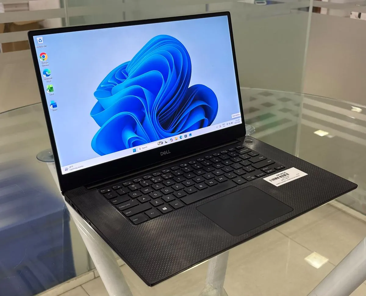 Dell XPS 15 9570, open, three-quarter view from the left showing the keyboard, trackpad and left-side ports