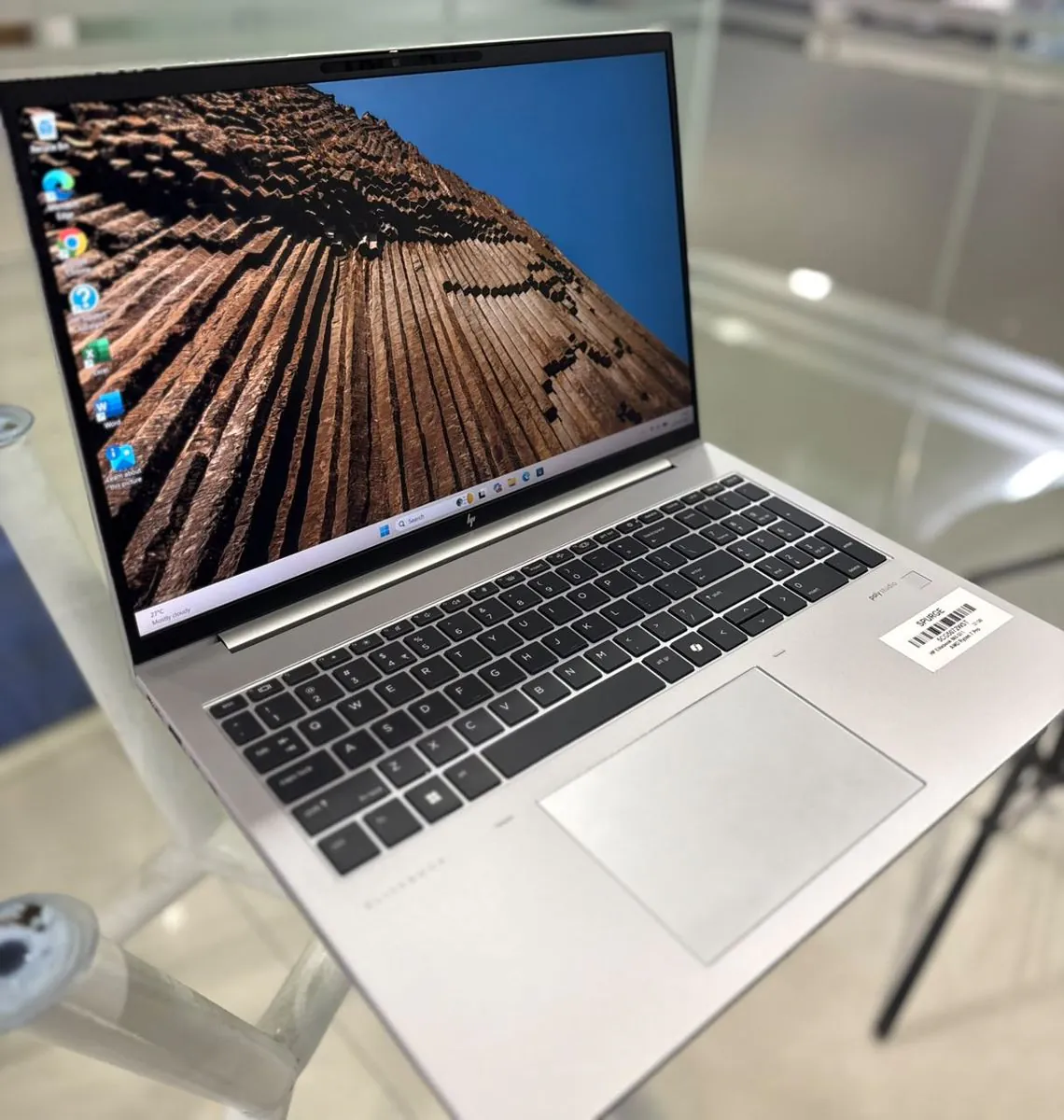 HP EliteBook 865 G11 from a left three-quarter angle with the display on