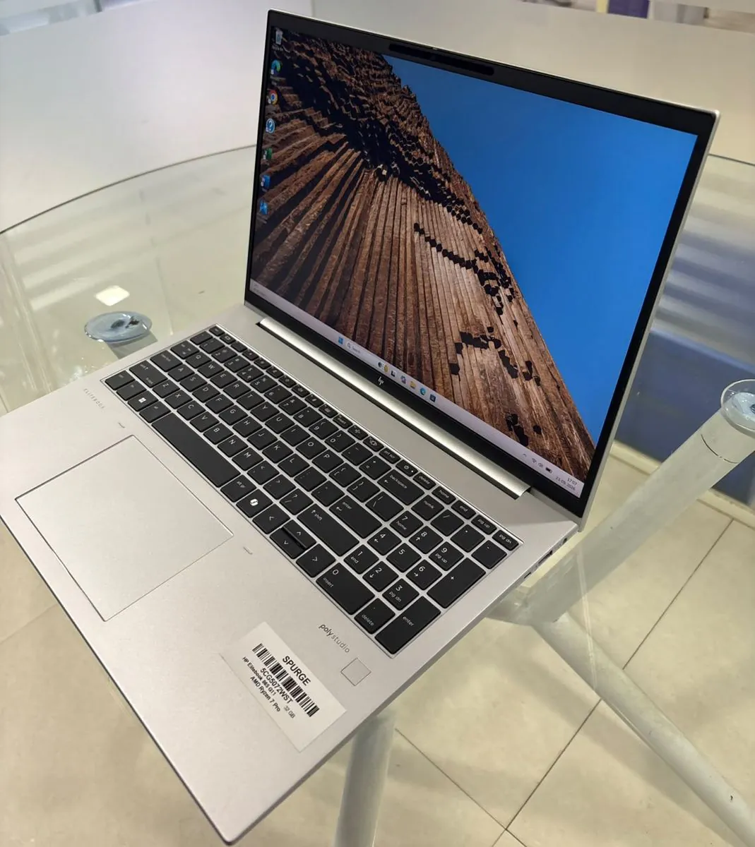 HP EliteBook 865 G11 from a right three-quarter angle, showing the numeric keypad, fingerprint reader and right side