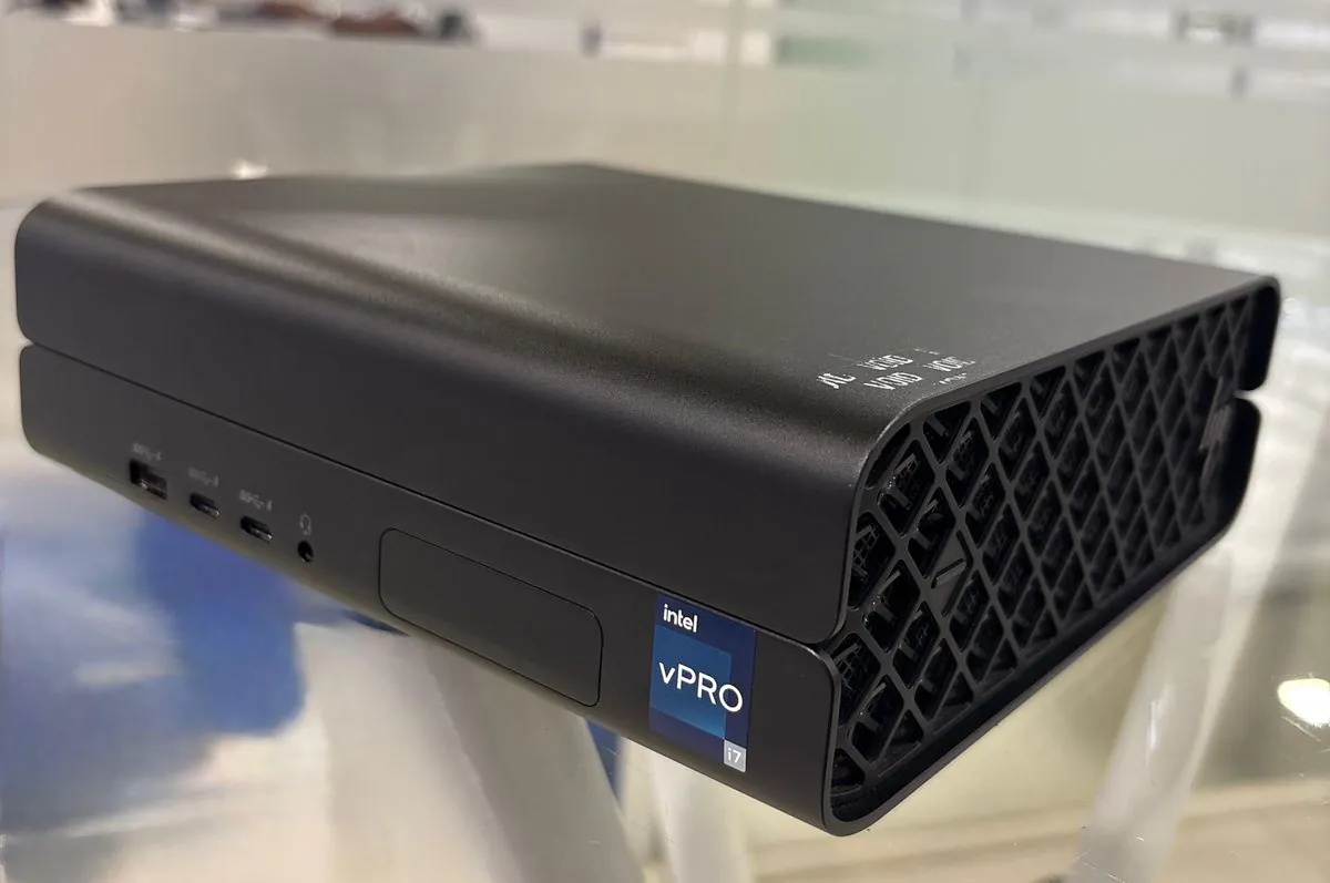 HP Z2 Mini G9 mini desktop workstation, front three-quarter view showing one USB-A and two USB-C ports, a headphone jack, the closed accessory bay door and the Intel vPro i7 badge