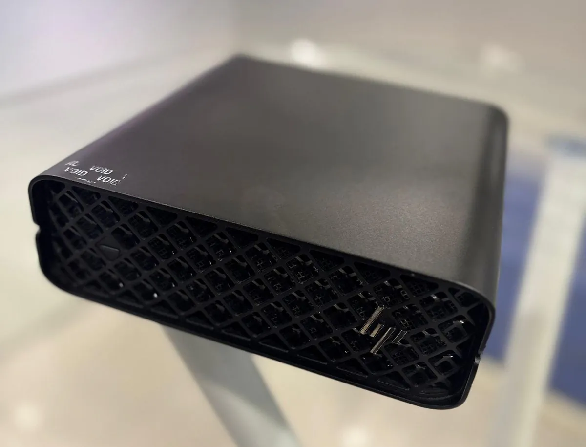 HP Z2 Mini G9 top panel and front-right vent mesh close up, showing the embossed HP logo and warranty seal text