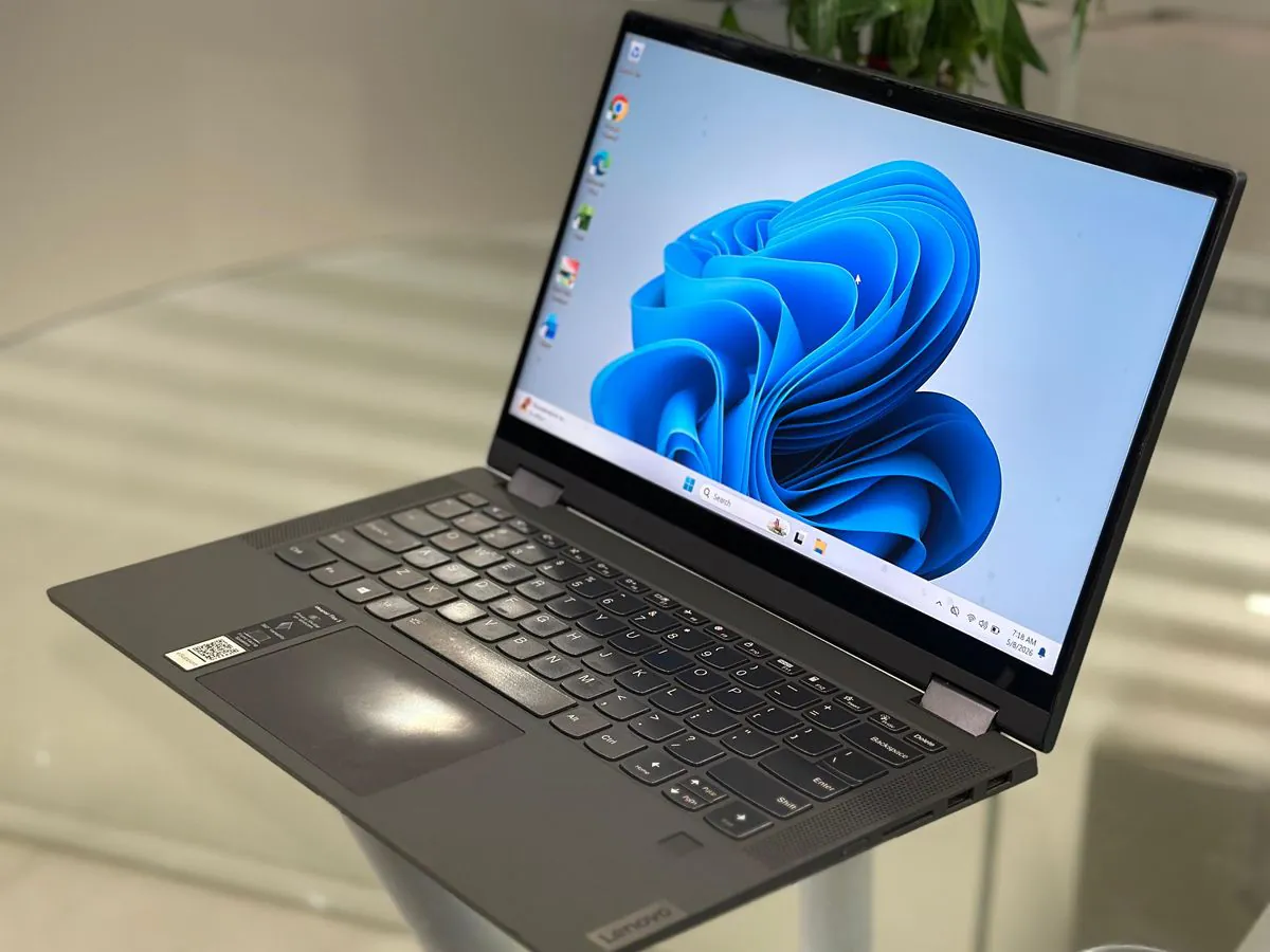 Lenovo IdeaPad Flex 5 14IIL05 from the right showing the keyboard deck, touchpad, right-side ports and palm-rest asset sticker with the display on