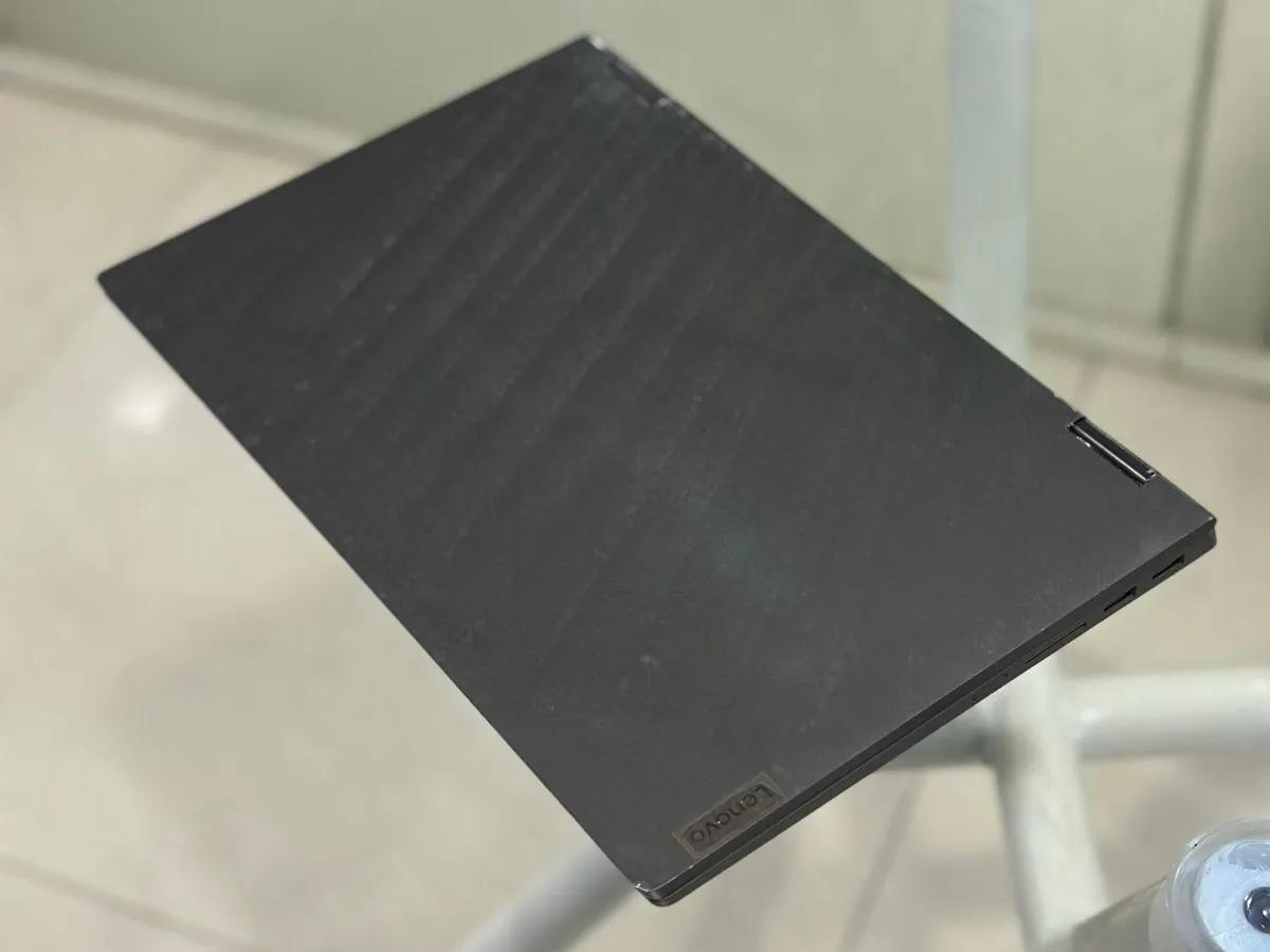 Closed graphite-grey Lenovo IdeaPad Flex 5 14IIL05 lid photographed from above on a glass table