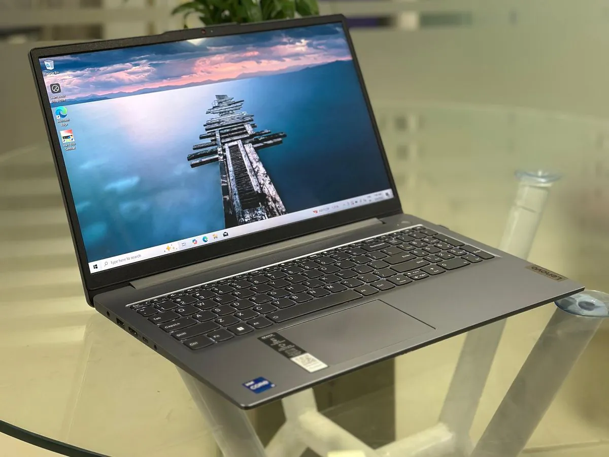 Lenovo IdeaPad Slim 3i 15IRH8 open at an angle with the display on, full keyboard with numeric keypad and 15.6-inch FHD screen visible