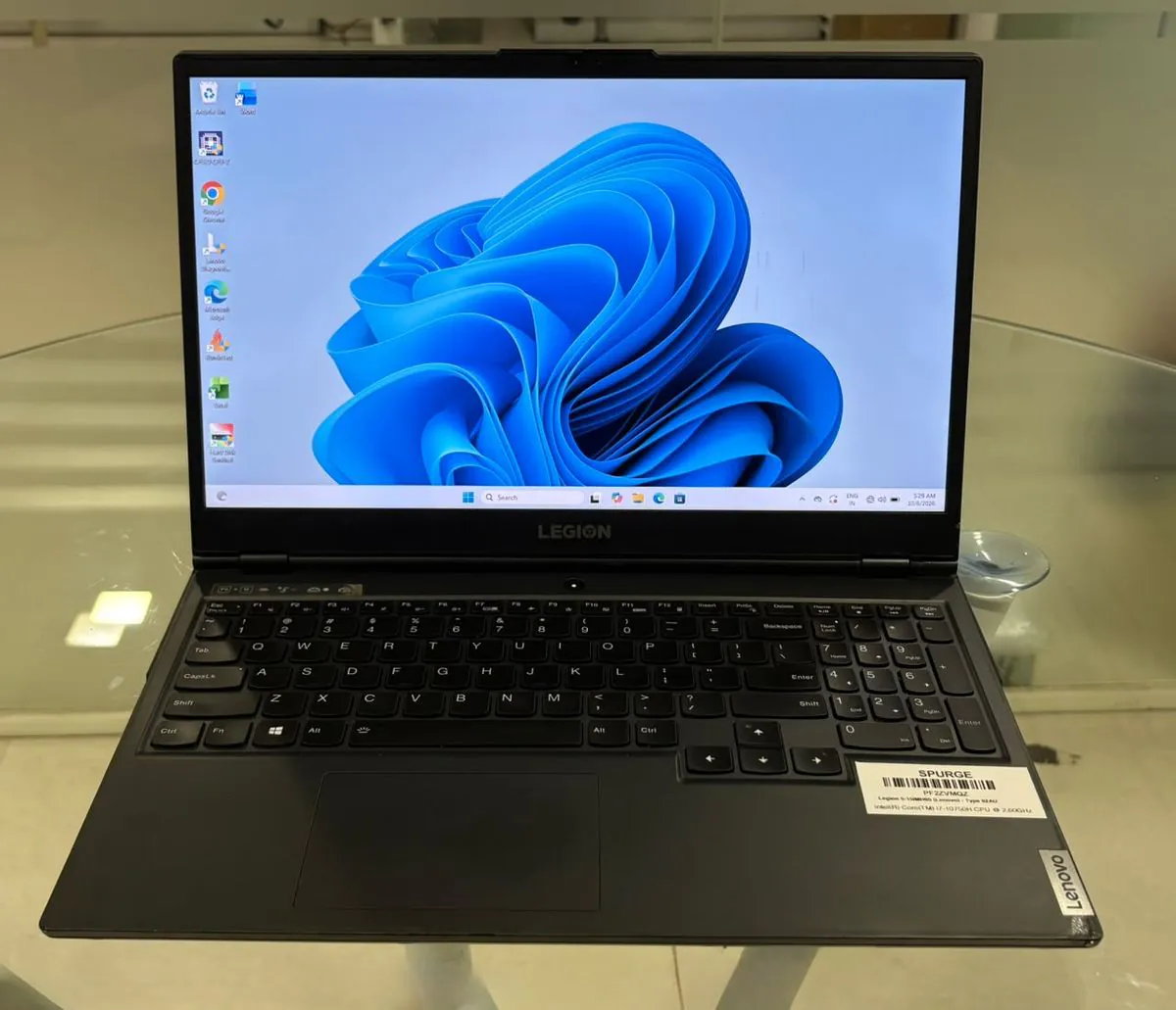 Lenovo Legion 5 15IMH05, open facing the camera with the Windows desktop on, showing the 15.6-inch display, full-size keyboard with numeric keypad and trackpad