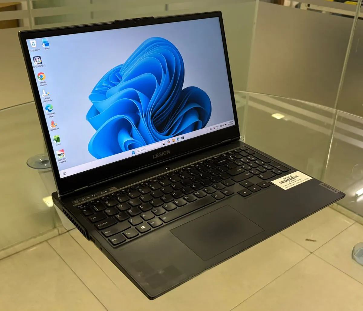 Lenovo Legion 5 15IMH05, open, three-quarter view from the left showing the display, keyboard and left-side vents