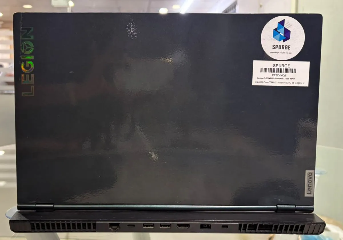 Lenovo Legion 5 15IMH05 closed, black lid with the Legion logo and SPURGE asset stickers above the rear port panel