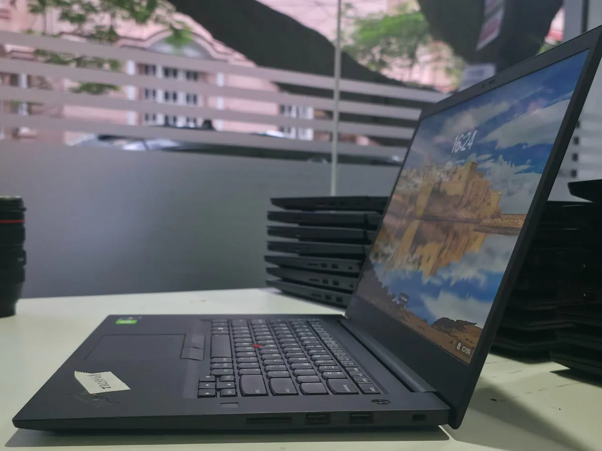 Lenovo ThinkPad P1 Gen 3 from a low left three-quarter angle with the display on and left side ports visible