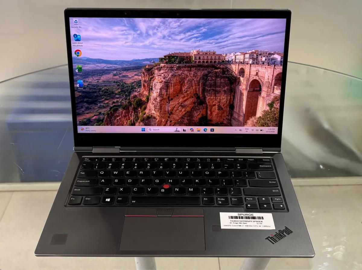Lenovo ThinkPad X1 Yoga 5th Gen in Iron Grey, open facing the camera with the Windows desktop on, showing the backlit keyboard, TrackPoint and fingerprint reader