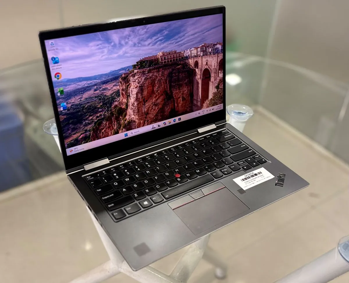 Lenovo ThinkPad X1 Yoga 5th Gen, open, three-quarter view from the left showing the keyboard, 360-degree hinges and left-side ports
