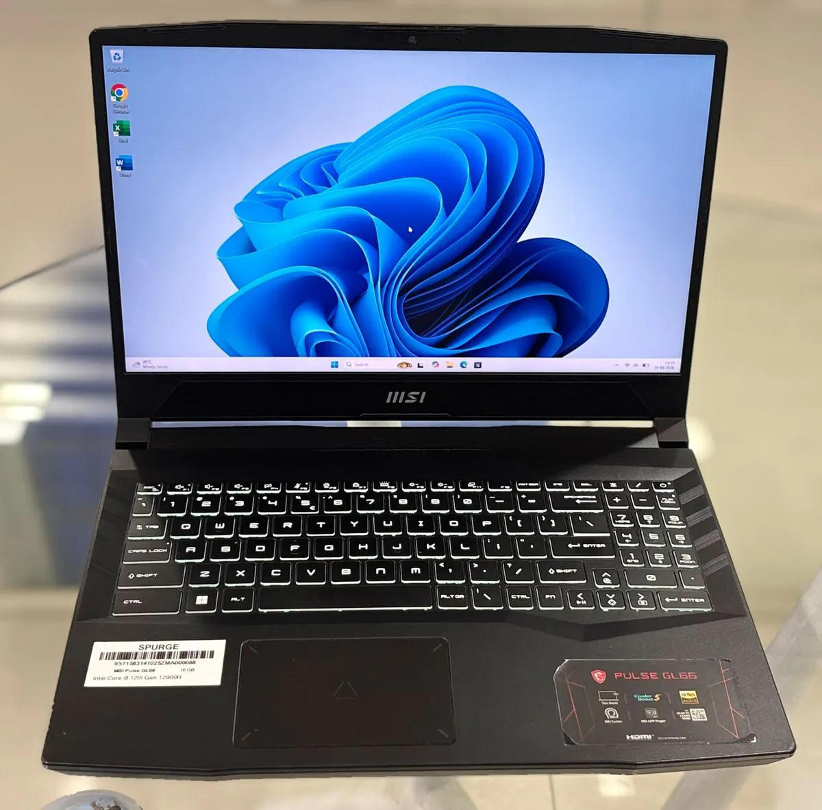 MSI Pulse GL66 open, facing the camera, showing the display, backlit keyboard with numeric keypad, and touchpad