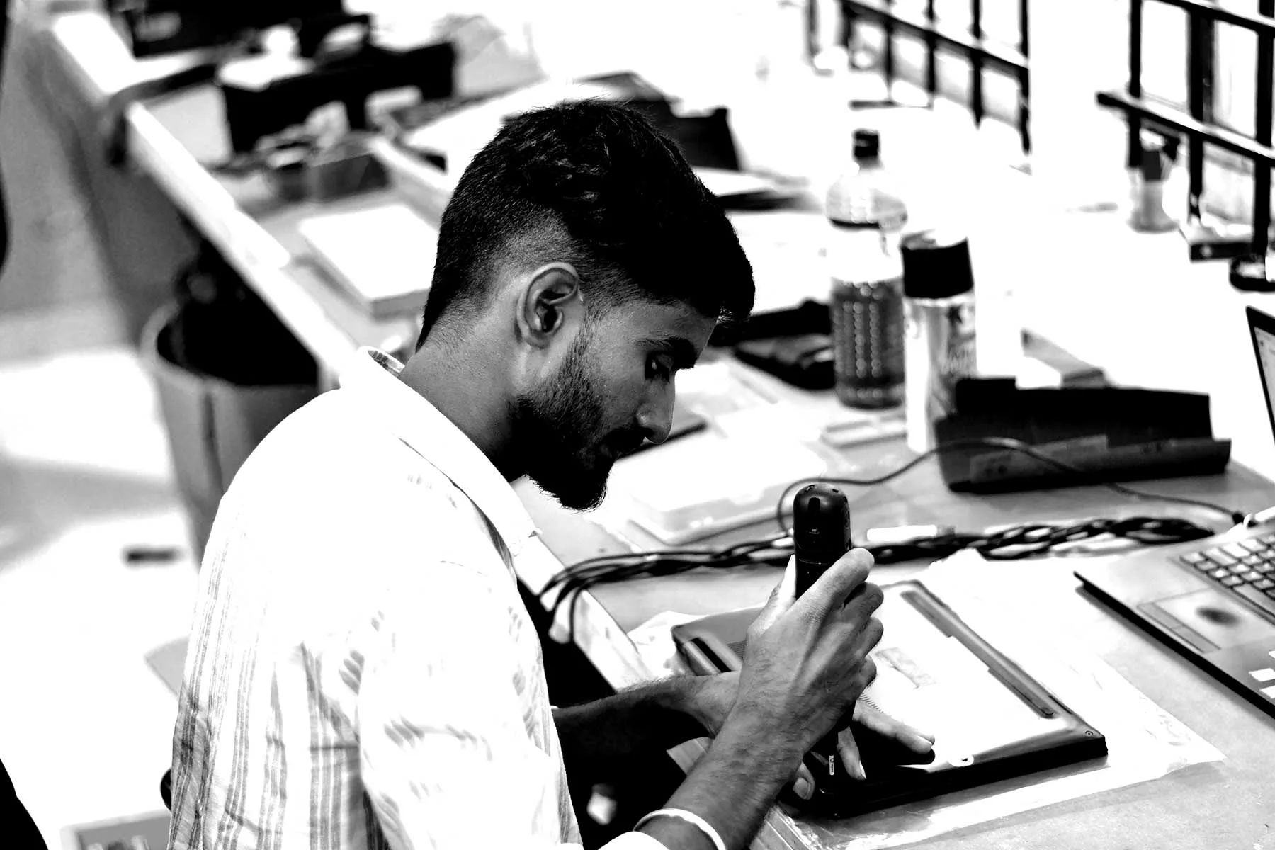 SPURGE team member inspecting a laptop during device preparation